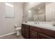 Clean bathroom featuring a vanity with cabinet space, tile flooring and large mirror at 3840 W Brogan Ct, New River, AZ 85087