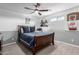 Cozy bedroom featuring a wooden bed frame, ceiling fan, wall decor and carpet flooring at 3840 W Brogan Ct, New River, AZ 85087