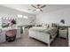Stylish bedroom with a white bed frame, green accent wall, lighted ceiling fan and vanity area at 3840 W Brogan Ct, New River, AZ 85087