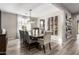 Elegant dining room featuring a decorative light fixture, wine rack, and seating for eight at 3840 W Brogan Ct, New River, AZ 85087
