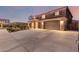 Charming two-story home with a stone-accented facade and a spacious three-car garage at 3840 W Brogan Ct, New River, AZ 85087