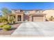 Charming two-story home with a stone-accented facade and a spacious three-car garage at 3840 W Brogan Ct, New River, AZ 85087