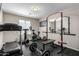 Home gym featuring various workout equipment, including a treadmill, weights and an exercise bike at 3840 W Brogan Ct, New River, AZ 85087