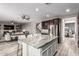 Open-concept kitchen featuring a center island with bar seating, stainless steel appliances, and hardwood floors at 3840 W Brogan Ct, New River, AZ 85087