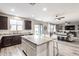 Spacious kitchen with island seating seamlessly connects to the well-lit living room, perfect for entertaining at 3840 W Brogan Ct, New River, AZ 85087