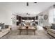 Open-concept living room showcases stylish furnishings, modern ceiling fan, and seamless flow into the kitchen at 3840 W Brogan Ct, New River, AZ 85087