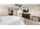 Spacious primary bedroom with a dark dresser, television, and comfortable decor at 3840 W Brogan Ct, New River, AZ 85087