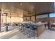 This outdoor kitchen has bar seating, ceiling fans and a great view of the backyard at 3840 W Brogan Ct, New River, AZ 85087
