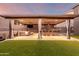 Relax in this backyard pergola, equipped with a TV, ceiling fan, heater, and bar with seating at 3840 W Brogan Ct, New River, AZ 85087