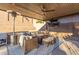 Enjoy this covered patio area, featuring a ceiling fan, heater, TV, wicker furniture and modern design at 3840 W Brogan Ct, New River, AZ 85087