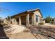 Relaxing backyard featuring a covered patio, cacti, and desert landscaping at 40915 N Columbia Trl, Anthem, AZ 85086