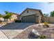 Charming single-story home with a two-car garage and low-maintenance desert landscaping at 40915 N Columbia Trl, Anthem, AZ 85086