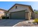 Charming single-story home with an attached two-car garage and desert-friendly landscaping at 40915 N Columbia Trl, Anthem, AZ 85086