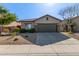 Charming single-story home featuring a well-maintained front yard with a tiled roof and a two car garage at 40915 N Columbia Trl, Anthem, AZ 85086
