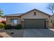 Charming single-story home featuring a well-maintained front yard with a tiled roof and a two car garage at 40915 N Columbia Trl, Anthem, AZ 85086