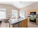 Bright kitchen with a breakfast bar, stainless steel appliances, and an adjacent dining area at 40915 N Columbia Trl, Anthem, AZ 85086