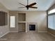 Cozy living room with tile floors and fireplace, perfect for relaxing evenings at 40915 N Columbia Trl, Anthem, AZ 85086