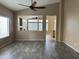 Inviting living room with wood-look floors, neutral paint, and modern ceiling fan at 40915 N Columbia Trl, Anthem, AZ 85086