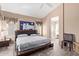 Main bedroom suite with wood-look floors, a ceiling fan, and an ensuite bathroom at 40915 N Columbia Trl, Anthem, AZ 85086
