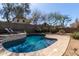 Inviting pool area with a sun deck and surrounded by mature trees for privacy at 40915 N Columbia Trl, Anthem, AZ 85086