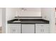 A quaint wet bar features cabinetry, countertop space, and a mini refrigerator at 4346 E Corral St, Phoenix, AZ 85044
