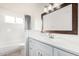 Bright bathroom with white vanity, framed mirror, and shower-tub combination at 4346 E Corral St, Phoenix, AZ 85044