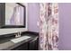 Cozy bathroom with floral curtain, dark vanity and granite countertop at 4346 E Corral St, Phoenix, AZ 85044