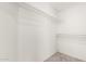 Walk-in closet features upper racks and neutral carpeting at 4346 E Corral St, Phoenix, AZ 85044
