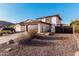 Exterior shot of a charming home with desert landscaping and a two-car garage at 4346 E Corral St, Phoenix, AZ 85044