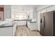 Bright kitchen featuring white cabinetry, stainless steel appliances, and wood-look flooring at 4346 E Corral St, Phoenix, AZ 85044