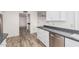 Updated kitchen boasts stone countertops, stainless steel dishwasher, and white cabinetry at 4346 E Corral St, Phoenix, AZ 85044