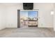 Bright living room with sliding glass doors to the outdoor deck. Neutral carpet flooring at 4346 E Corral St, Phoenix, AZ 85044