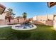 Backyard pool with artificial grass, decorative walls, and mountain views at 4346 E Corral St, Phoenix, AZ 85044