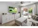 Comfortable living room with TV and access to a beautiful outdoor patio with lush foliage at 4800 N 68Th St # 225, Scottsdale, AZ 85251