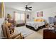 Comfortable bedroom with a ceiling fan, natural light, and a sitting area at 5139 N 76Th Pl, Scottsdale, AZ 85250