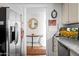 Hallway leading to a room with a refrigerator, dishwasher, and granite countertops at 5139 N 76Th Pl, Scottsdale, AZ 85250