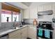 Bright kitchen featuring granite countertops, a stainless steel range, and a window for natural light at 5139 N 76Th Pl, Scottsdale, AZ 85250