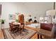 Open living space with a fireplace, vaulted ceilings, and terracotta tile flooring with decorative rugs at 5139 N 76Th Pl, Scottsdale, AZ 85250