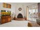 Cozy living room featuring a unique rounded brick fireplace with a decorative accent and natural light at 5139 N 76Th Pl, Scottsdale, AZ 85250