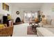 Cozy living room with a unique brick fireplace, plush carpeting, and comfortable seating at 5139 N 76Th Pl, Scottsdale, AZ 85250
