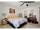 Bright main bedroom featuring carpet, ceiling fan and ensuite access with updated vanity and decorative mirrors at 5139 N 76Th Pl, Scottsdale, AZ 85250