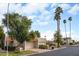 Street view featuring terra cotta rooflines, lush desert landscaping, and tall palm trees at 5139 N 76Th Pl, Scottsdale, AZ 85250