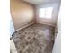 Bright bedroom with plank-style flooring, neutral walls, and natural light from the large window at 5316 W Lynwood St, Phoenix, AZ 85043