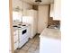 Efficient kitchen featuring tile flooring, white appliances, and ample counter space at 5316 W Lynwood St, Phoenix, AZ 85043