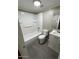 Bathroom featuring tub/shower combo, white vanity, and gray wood-look flooring at 5420 W Lynwood St, Phoenix, AZ 85043
