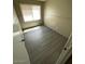 This bedroom features neutral walls, gray wood floors, a window and a paneled door at 5420 W Lynwood St, Phoenix, AZ 85043