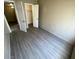 Bedroom with light gray wood-look floors and white closet door at 5420 W Lynwood St, Phoenix, AZ 85043