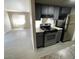 Kitchen showcasing black appliances, light countertops, and light gray wood-look floors at 5420 W Lynwood St, Phoenix, AZ 85043