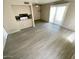 Living room featuring light gray wood-look flooring, ceiling fan, and natural light at 5420 W Lynwood St, Phoenix, AZ 85043