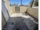 This patio area features stucco walls, a metal gate and neutral colored floor at 5420 W Lynwood St, Phoenix, AZ 85043